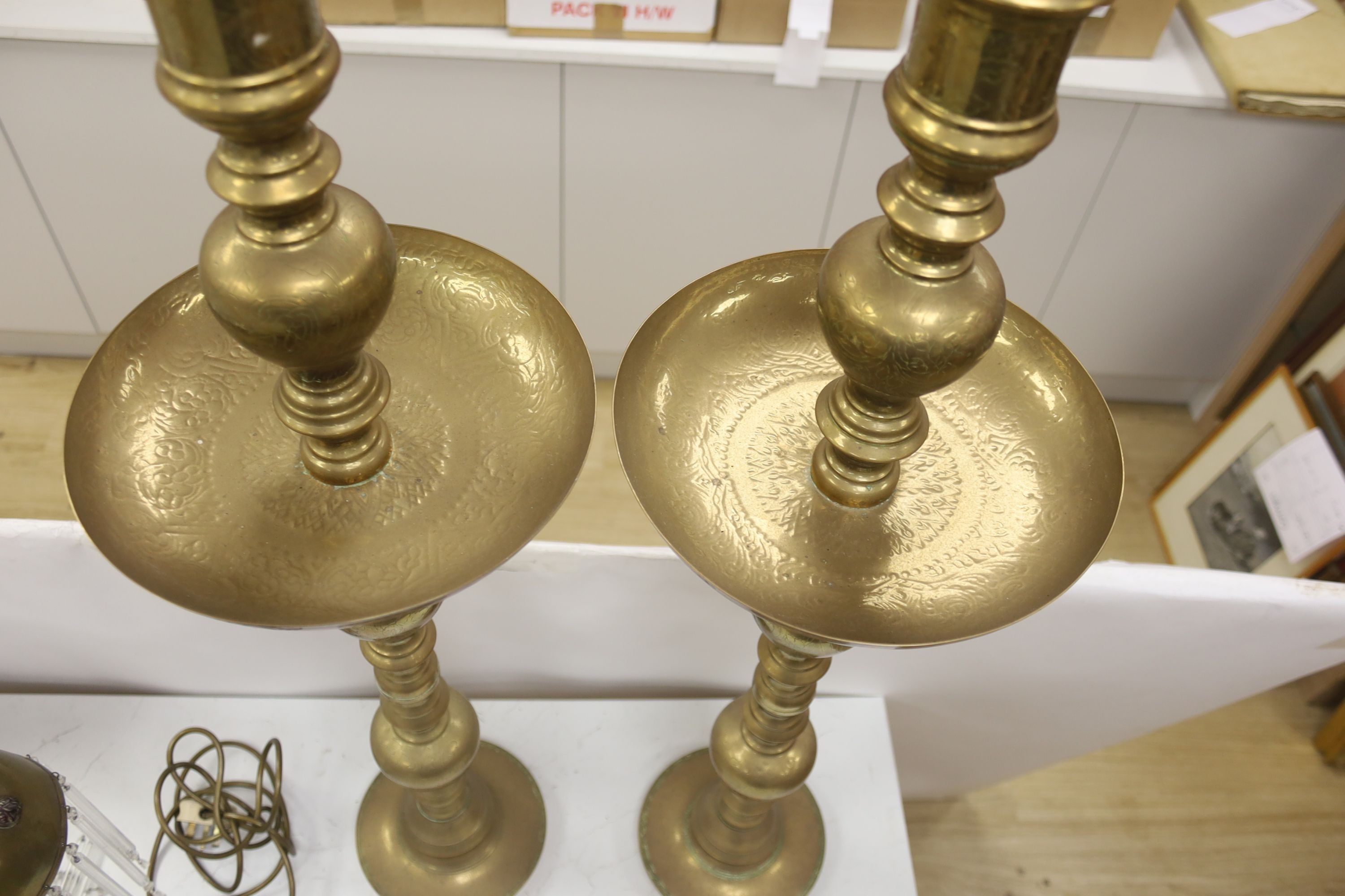 A pair of Benares engraved brass floor lamps 89cm